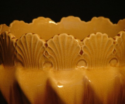 yellow majolica jardiniere with a shell pattern detail
